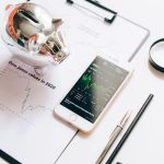 A trading platform open on a phone, displaying real-time forex and crypto market trends.
